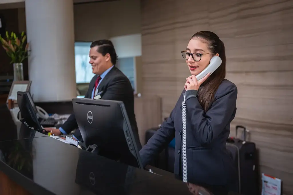 A smiling customer support agent on the phone representing retention strategies